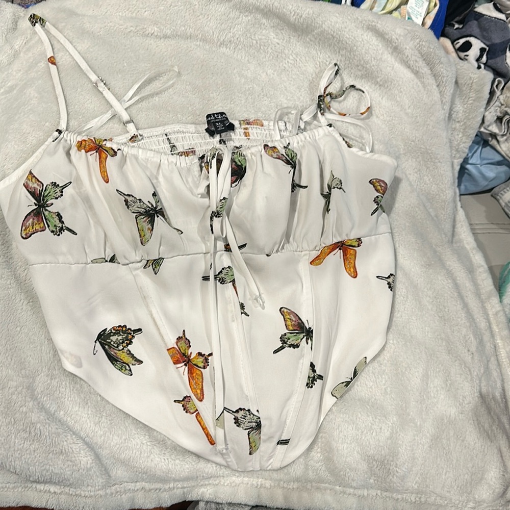 White spaghetti strap crop top with colorful butterflies.